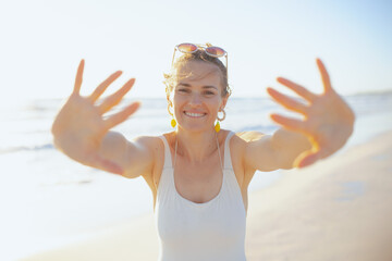 smiling woman in beachwear at beach having fun time