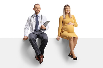 Male doctor and a pregnant woman sitting on a blank panel