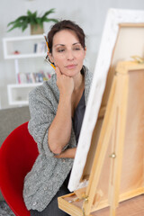 woman searching for creative ideas in front of an easel