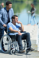 Obraz premium man in a wheelchair looking at the sea