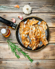 Fried bacon with olive oil and rosemary.