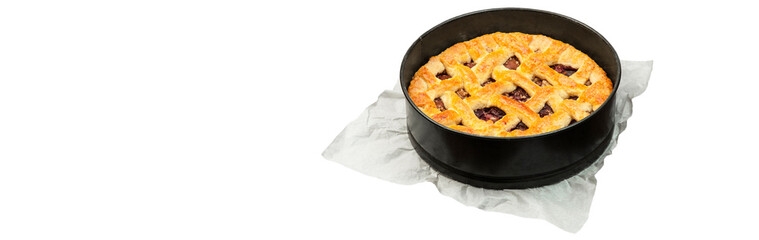 shortbread pie with plums on a baking sheet on a white background. concept of homemade shortcrust pastry. baked fruit dessert from the oven on a light texture close up