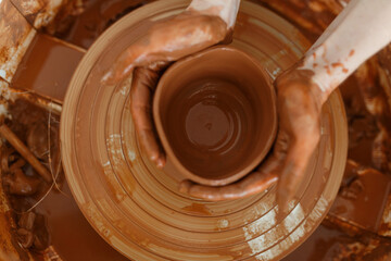 Clay pottery workshop, the process of making ceramic crockery. Woman hand holding raw clay plate