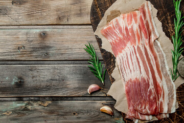 Raw bacon on paper.