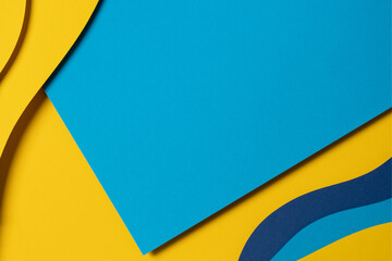 Abstract colored paper texture background. Minimal paper cut composition with layers of geometric shapes and lines in light blue, navy blue, yellow colors