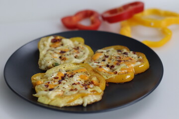 Cheesy vegetarian egg ring. Easy and healthy breakfast. Omelet prepared in bell pepper rings with cheese oregano and chili flakes toppings