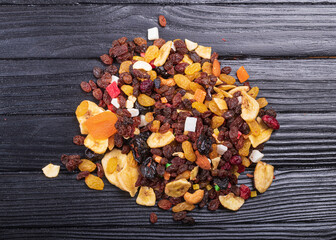 wooden background in retro style. a mixture of dried fruits lies on it. close-up. there is a...