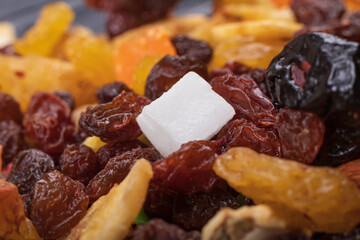 wooden background in retro style. a mixture of dried fruits lies on it. close-up. there is a...