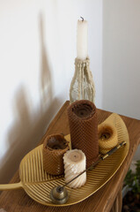 Homemade craft candles made of honeycomb in the interior of a room, apartment,house