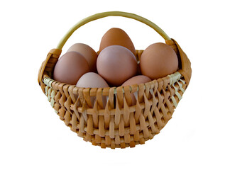 Chicken eggs in a basket with willow vines isolated on white background