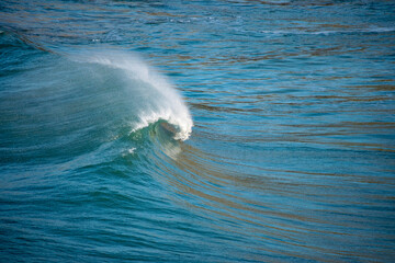 A breaking wave on a sunny day