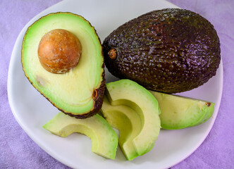 Two fresh ripe raw hass avocados, close up, healthy food concept