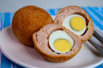 Traditional street food in UK, stuffed fried Scotch eggs with breadcrumbs