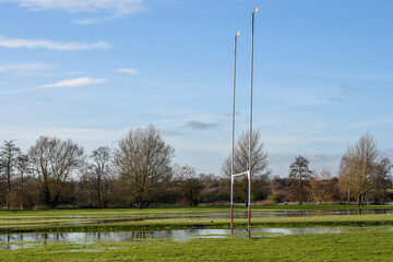 Flooded sports pitch after heavy rain the field is waterlogged