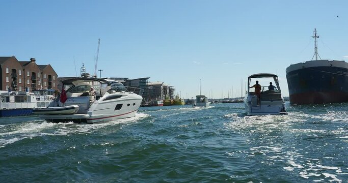 A short full HD 4k video clip of a variety of motorboats leaving Poole Harbour passing a historic quay