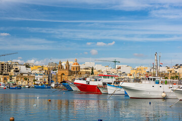 Fototapeta na wymiar Colorful boats in Marsaxlokk fisherman village in Malta