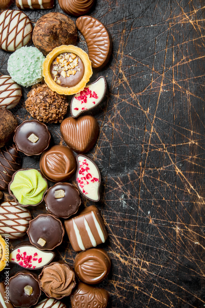 Poster Chocolate sweets on a wooden Board.