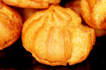 Several sweet chouquette, close-up, isolated on black.
