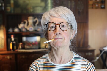 Senior woman smoking a cigarette