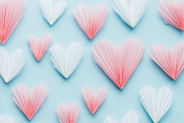 Valentines day flat lay. Stylish pink and white hearts composition on blue paper background. Happy...