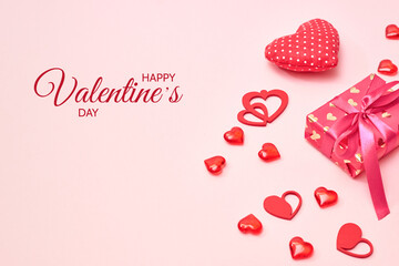 Valentines day frame with gift box and red hearts on a pink background. Happy Valentine's Day celebration text