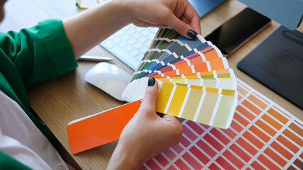 Designer choosing colors for his future project in art studio.