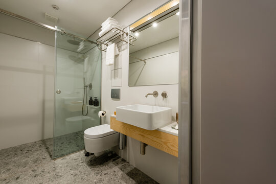 interior of modern white bathroom with sink and toilet.