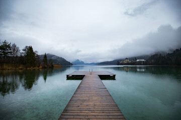 Wooden pier with clear lake in the Alps in summer, Wooden pier at Lake Fuschlsee in summer, Salzburg, Austria