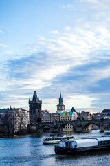 Fototapeta premium Taking a photograph in Karlov Bridge, Prague Bridges in the Summer on the Sunset. Czech Republic. Prague, Czech Republic. Panoramic cityscape image of famous Charles Bridge in Prague during beautiful 