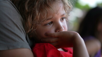 Bored pensive little boy on father lap. thoughtful child waiting