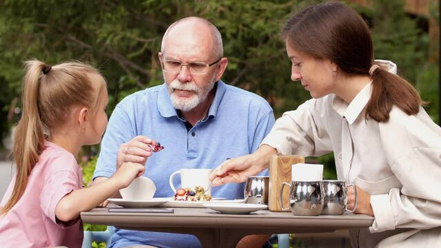 Family breakfast in a street cafe