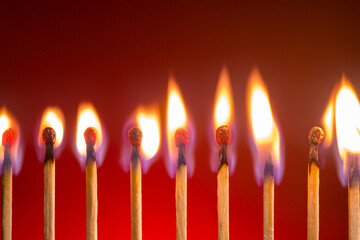 Matches burning on red gradient background.