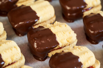 Christmas cookies filled with jam and dipped in chocolate