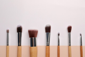 Set of makeup brushes on color background, flat lay. Space for text