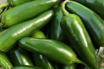 Green hot chili peppers as background, closeup