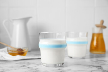 Delicious milk and honey on white marble table