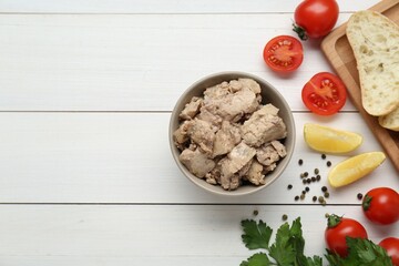 Flat lay composition with tasty cod liver and different products on white wooden table. Space for text