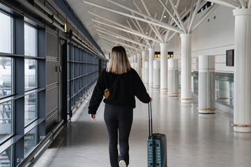 Young woman walking in the airport before traveling