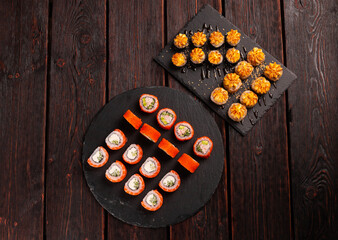 Rolls set with fish shrimp and caviar sushi with chopsticks - asian food and japanese cuisine concept