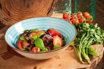 salad with beef on the wooden background