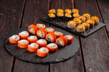 Rolls set with fish shrimp and caviar sushi with chopsticks - asian food and japanese cuisine concept