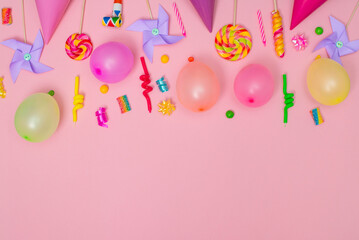 Child birthday party border on pink background with copy space. Baloons, candles, candies, sweets.