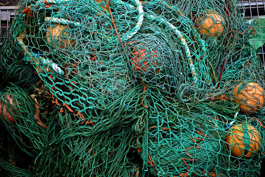 A close up of a pile of fishing nets and ropes - Powered by Adobe