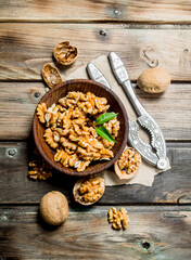 Fototapeta premium Shelled walnuts with a Nutcracker.