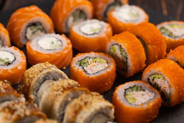 Rolls set with fish shrimp and caviar sushi with chopsticks - asian food and japanese cuisine concept