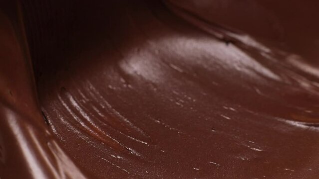 Knife stirs chocolate hazelnut butter slow motion