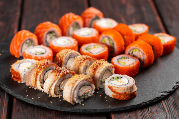 Rolls set with fish shrimp and caviar sushi with chopsticks - asian food and japanese cuisine concept