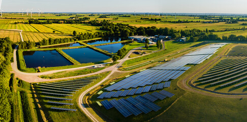 Panorama view of environmentally friendly installation of photovoltaic power plant and wind turbine...