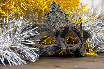 Beautiful New Year's mask on the background of shiny tinsel.