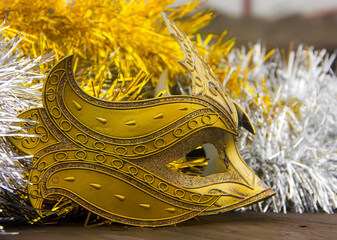 Beautiful New Year's mask on the background of shiny tinsel.